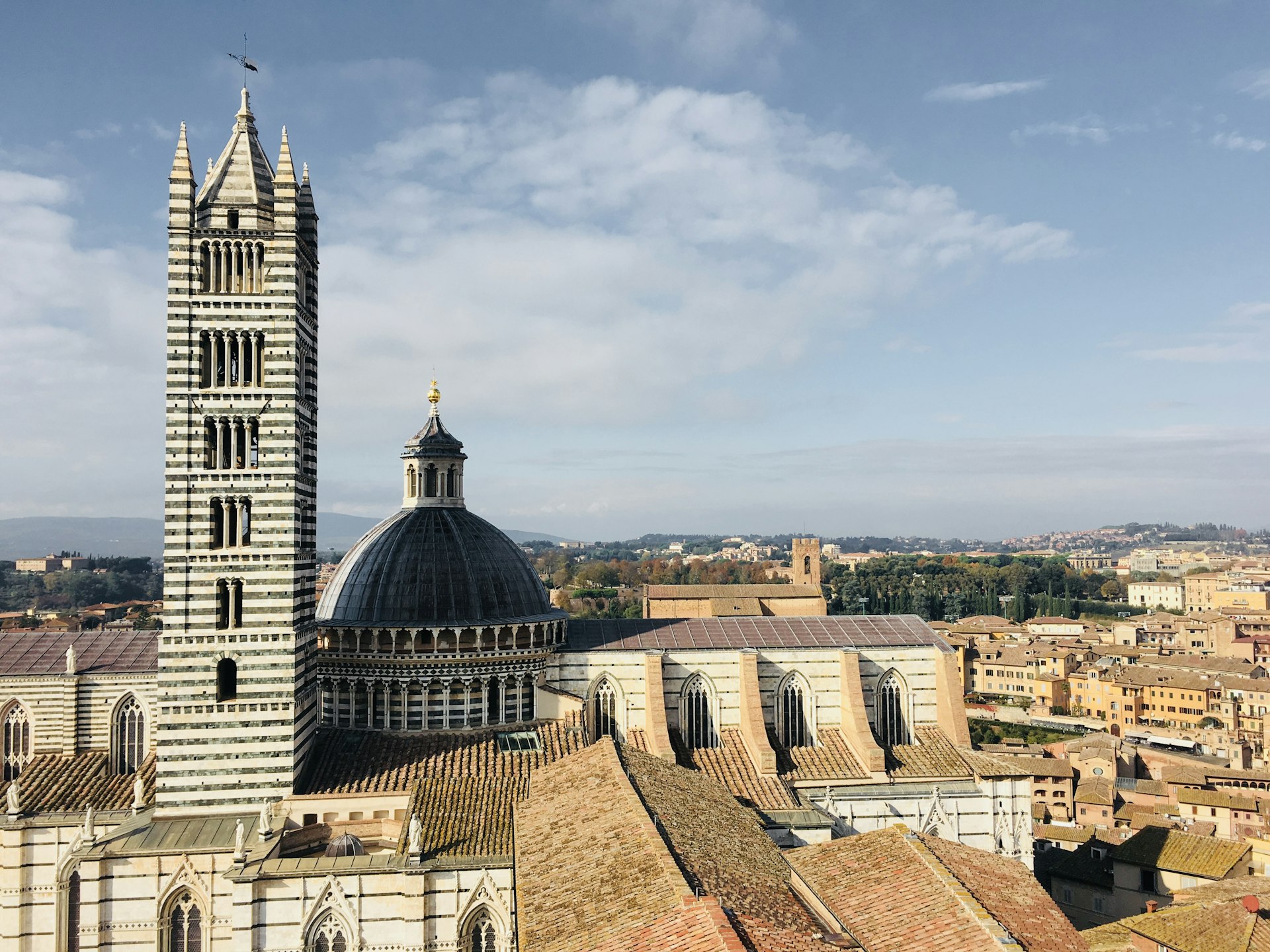 The striped façade of Siena Cathedral on a sunny day